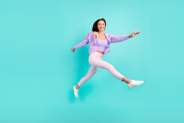 Fototapeta na wymiar Photo of carefree inspired sporty lady jump run go wear purple cardigan pants shoes isolated turquoise color background
