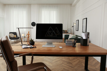 Workplace with computer on wooden desk in light room. Modern interior design