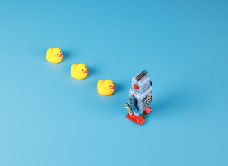 vintage retro robot and Yellow Rubber Bath Ducks, leadership concept