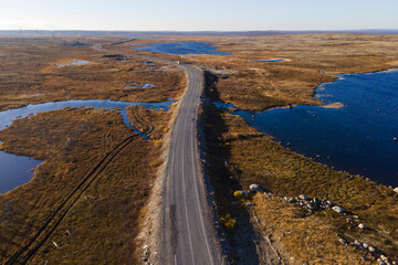 Aerial view of lake and road going away in tundra in Murmansk oblast, north of russia in autumn