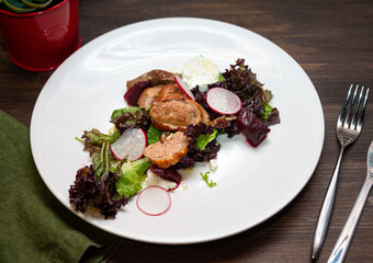 Duck breast salad sous vide. Arugula salad, lola rossa, duck breast, beets, radishes, cashews, goat cheese, lime, olive oil.