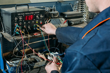 Obraz premium car service, an employee repairs and tests car parts