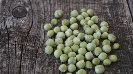 green peas on wooden background