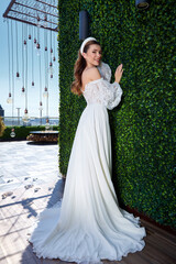 Fototapeta premium Sexy beautiful brunette woman pretty bride wedding big day marriage ceremony in summer garden wearing long silk and lace white dress bright makeup hairstyle pure love interior.
