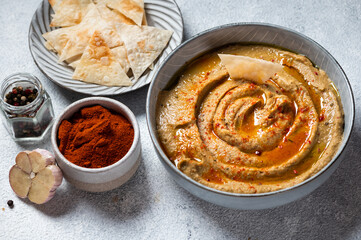 Traditional arabian eggplant dip baba ganoush with herbs and smoked paprika on light background. Eggplant hummus. Babaganush or eggplant caviar. Baked eggplant. Turkish eggplant dip