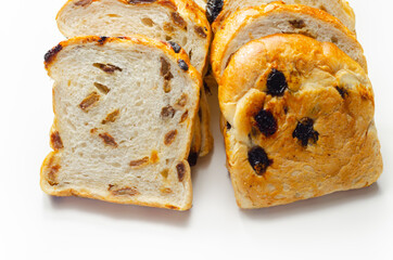 Fruit loaf with sultanas and orange flavored pieces on the white background