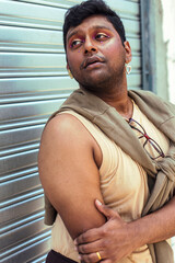 portrait of dark skinned Indian man in Malaysia, with theatrical facial expressions, in the...