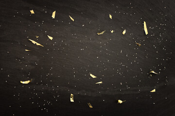 Black slate and golden confetti background