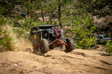 Fototapeta premium UTV, ATV, 4x4 off road vehicle in sandy open area. Buggy extreme riding