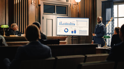 Court of Law Trial in Session: Portrait of Charismatic Male Public Defender Showing Analysis of Financal Crime on TV Screen to Judge and Jury. Attorney Lawyer Protecting Client, Presenting Case. - obrazy, fototapety, plakaty