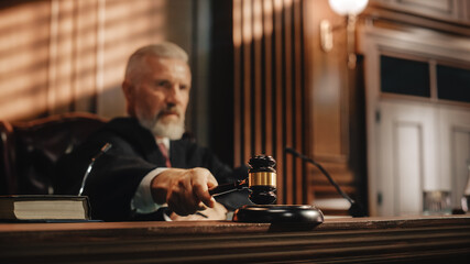 Court of Law and Justice Trial Session: Imparcial Honorable Judge Pronouncing Sentence, striking Gavel. Focus on Mallet, Hammer. Cinematic Shot of Dramatic Not Guilty Verdict. - obrazy, fototapety, plakaty