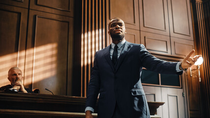 Court of Law Trial in Session: Portrait of Charismatic Male Public Defender Making Touching,...