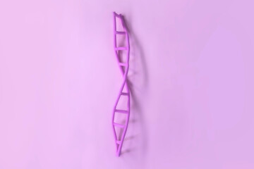 Artificial DNA model on pink background