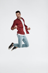 Young european man enjoying triumph and jumping