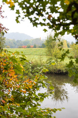 Colorful trees with German village in background along a river