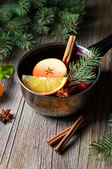 tasty mulled wine hot drink with mandarin orange apple spices and christmas tree in pot