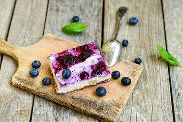 Homemade ketogenic  cheesecake with Blueberry   sauce .Healthy organic summer dessert  on wooden background