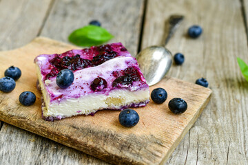 Homemade ketogenic  cheesecake with Blueberry   sauce .Healthy organic summer dessert  on wooden background