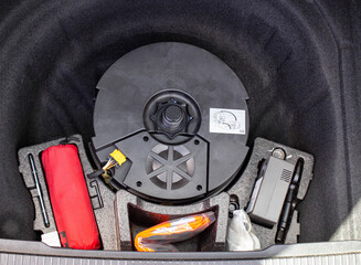 original subwoofer, first aid kit and compressor for inflating wheels in a car trunk niche