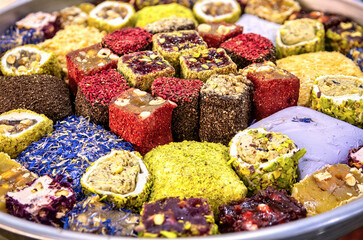 Oriental sweets. Assorted traditional Turkish delight (Rahat lokum) on dish. Turkish delight with different nuts and coconut shavings. Top view Close-up.