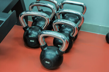 Naklejka na ściany i meble several weights for fitness classes are standing against the wall of the gym