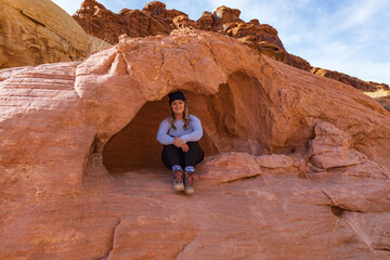 Smiling girl sitting in crevasse at Valley of Fire State Park