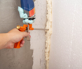 Construction foam gun with a defective cylinder. Foam bottle defect, close-up