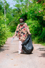 Fototapeta na wymiar Senior woman picking up plastic bottle, garbage collecting in a forest cleaning planet. environment protection pollution problems and global warming, plastic waste caring about nature concept.