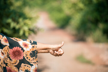 Tourist woman call for help of car breakdown. lady help of car breakdown. Old woman waving for help on the road by a broken car in the forest.