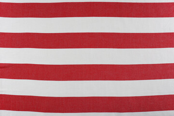 Striped beach towel as background, top view