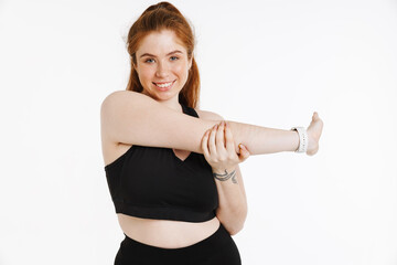 Smiling young plus size fitness woman in sportswear