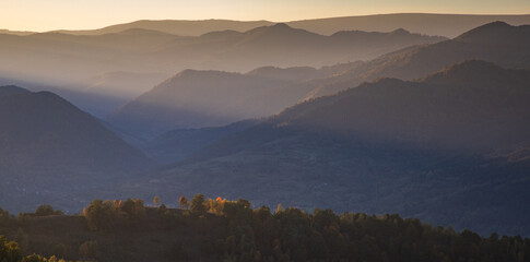 beautiful autumn landscape with hills at sunset