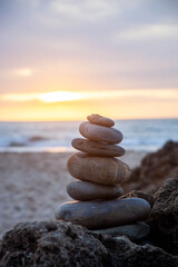 Zen meditation relaxation concept background - balanced stones stack close up on sea beach