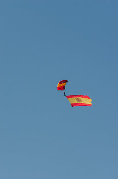 Vertical photo of a parachutist with the Spanish flag falling in the military parade of the National Day of Spain on October 12 - Madrid.