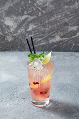 cocktail with ice over grey background