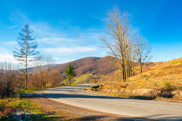 pass through carpathian mountains. trees along the road descending in to the valley of volovets,...