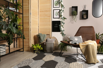 Lounge area interior with comfortable armchair and beautiful houseplants