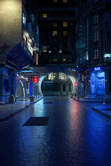 Dark and moody urban street view in a futuristic city at night, realistic 3D rendering in portrait format with copy space.