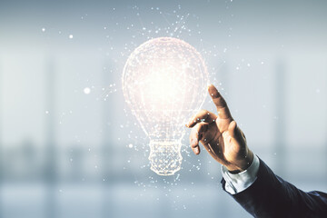 Man hand working with abstract virtual light bulb hologram on blurred office background, idea...