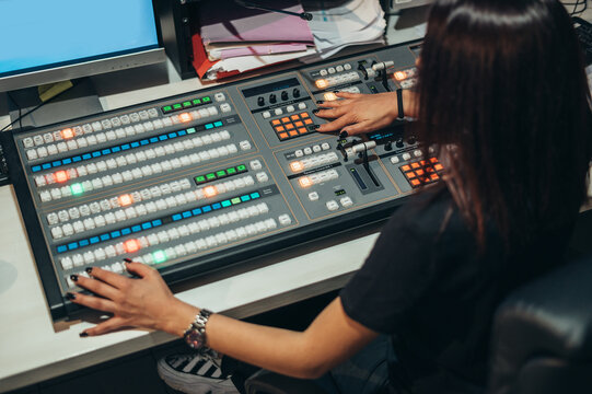 Young beautiful woman working in a broadcast control room on a tv station