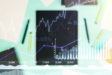Abstract creative financial graph and modern digital tablet on desktop on background, top view,...
