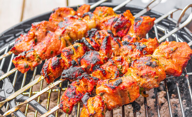 Russian shashlik with skewers on a round grill.