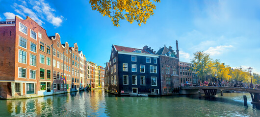 Amsterdam. Panoramic view of the historic city center of Amsterdam. Traditional houses  of Amsterdam. Beautiful autumn sunny day. A European travel to a historic town. 