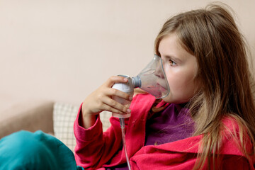 Cute child patient inhalation therapy by the mask of inhaler