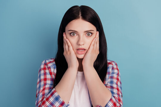 Photo of young girl hands touch cheeks amazed surprised shock news isolated over turquoise color background