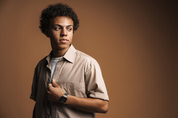 Fototapeta premium Young black man in shirt posing while looking aside