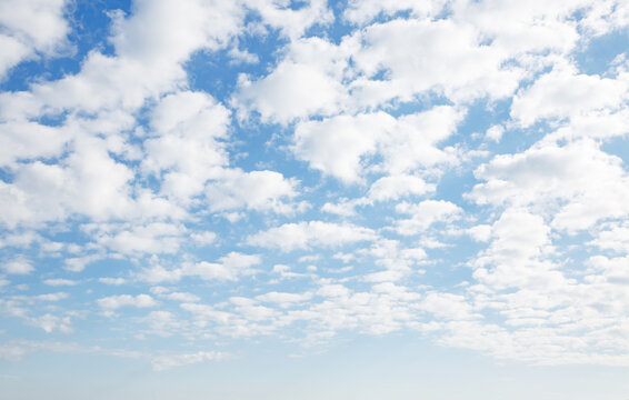 Captivating blue sky with white fluffy clouds in sunny day.