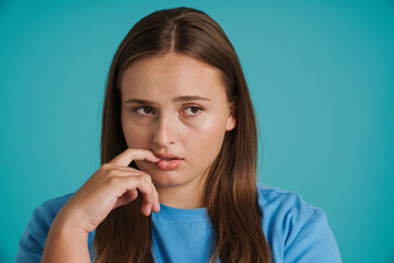 Young white woman wearing t-shirt frowning and looking aside