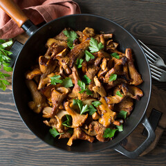 frying pan with fried chanterelles on the table © kochabamba