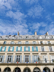 Fototapeta na wymiar Typical architectural features of parisian buildings. Stone repetitive facade with blu zinc plates roof